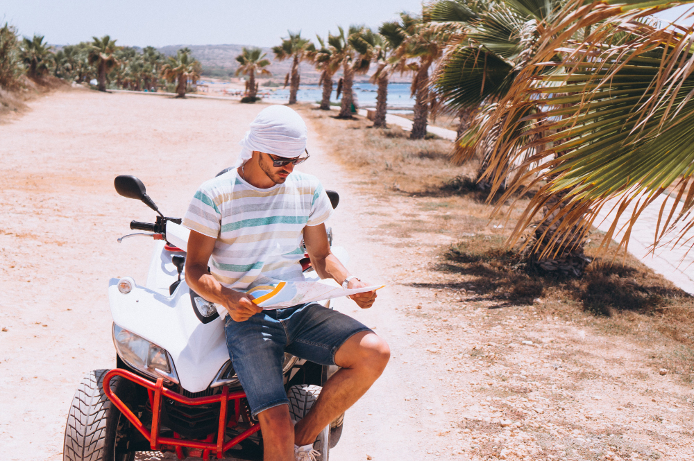 man-with-map-travalling-atv-by-sea